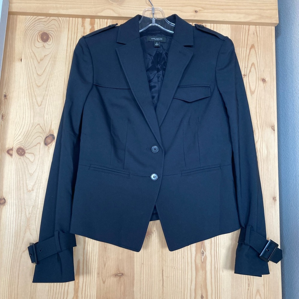 Never been worn unique and versatile navy blazer with sleeve buckle details.